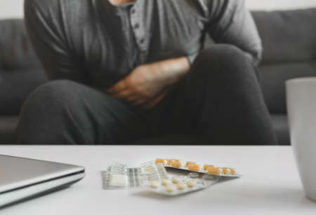 Man suffering from stomach pain at home.の写真素材