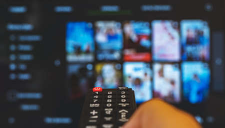Male hand with remote control pointing on Smart TV.の写真素材