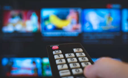 Male hand with remote control pointing on Smart TV.の写真素材