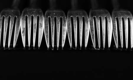 Composition made of forks on the black background.の写真素材