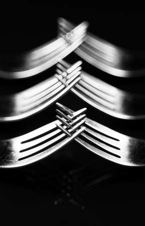 Composition made of forks on the black background.の写真素材