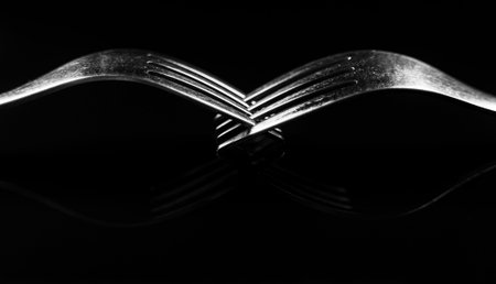 Composition made of forks on the black background.