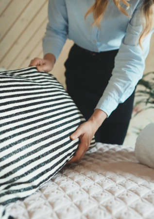 Woman loading clothes into washing machine.の写真素材