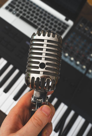 Man holding retro microphone in music studio.の写真素材