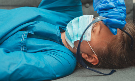 Tired medical worker after a shift. Burnout at work.の写真素材