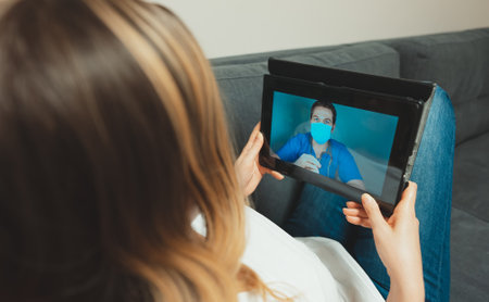 Woman making video call with her doctor.の写真素材