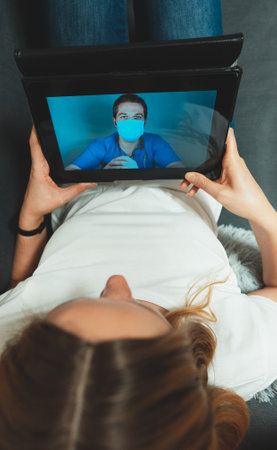 Woman making video call with her doctor.の写真素材