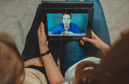Family making video call with their doctor.の写真素材