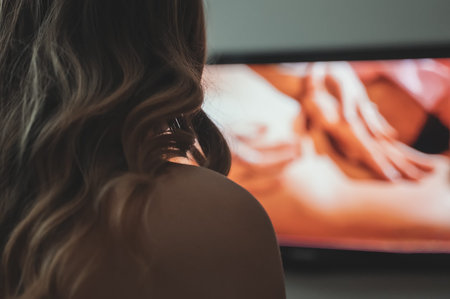 Woman watching erotic film on TV.