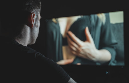 Man watching erotic film late at night.の写真素材