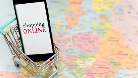Mobile phone in shopping trolley. Online shopping concept.
