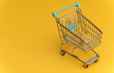 Empty shopping cart on yellow background.の写真素材