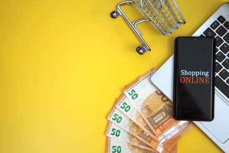 Mobile phone, shopping cart and money. Online shopping concept.の写真素材