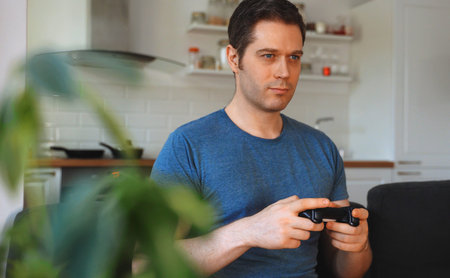 Handsome man with joystick playing game.