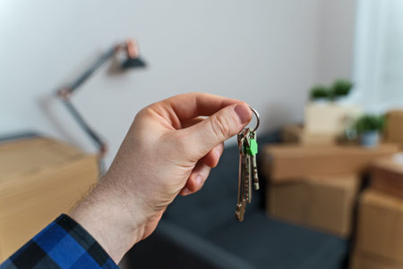 Hand with house key. Real estate and moving concept.