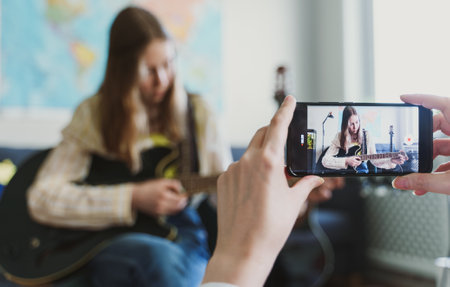 Mom records her daughter on the phone. Video blog concept.の写真素材