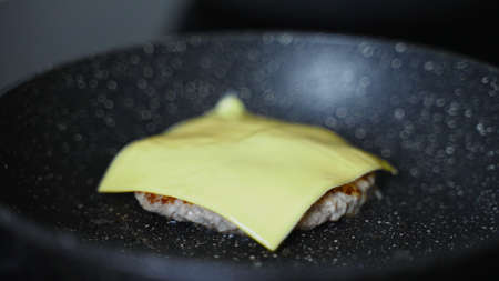 Beef cutlet for hamburger preparing on the pan.の写真素材