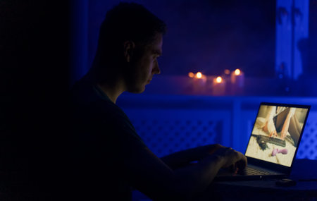 Man chatting with webcam model late at night.