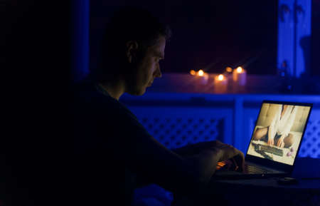 Man chatting with webcam model late at night.の写真素材