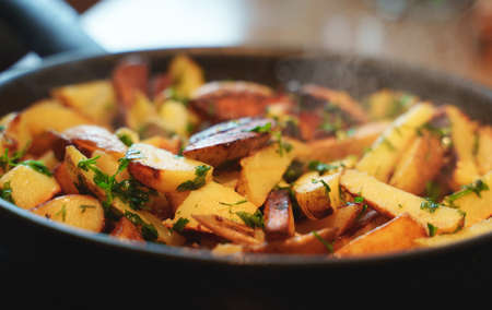 Fried village potatoes with herbs.の写真素材