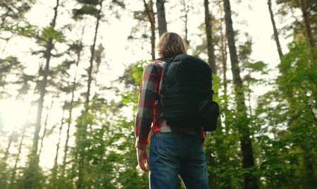 Man with backpack and sunglasses in the woods. Arc shoot.の写真素材