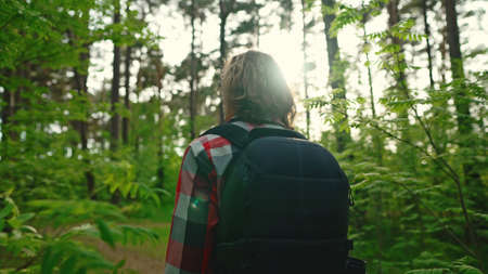 Man with backpack and sunglasses in the woods. Arc shoot.の写真素材