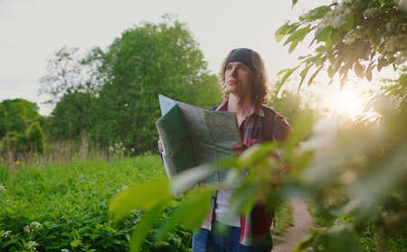 Male tourist with map and backpack in the forest.の写真素材