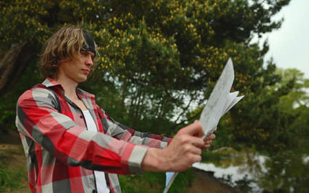 Male tourist with map by the lake.の写真素材