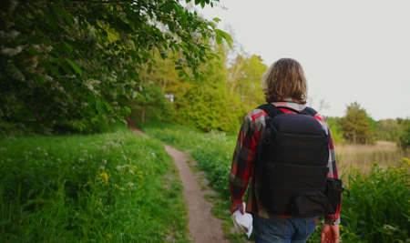 Man with rucksack walking in the forest.の写真素材