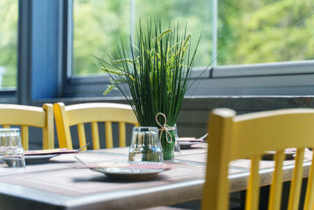 Setout table with tableware in modern restaurant in summer.の写真素材