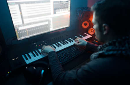 Sound producer working in recording studio.の写真素材