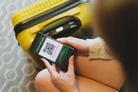 Woman in airport checking virus vaccine certification app. Status is not valid.の写真素材