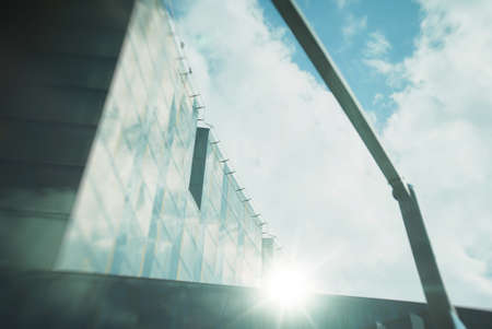 Sun rays are reflected in the glass of modern hotel.の写真素材