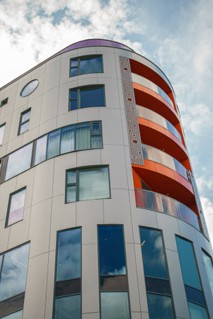 Modern architecture. House with a multi-colored facade and balconies.