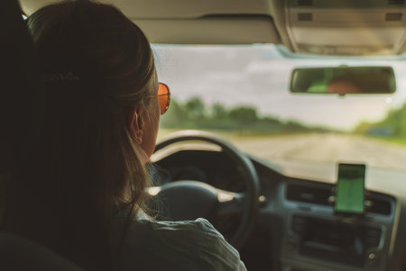 Woman driving a car in summer time.の写真素材