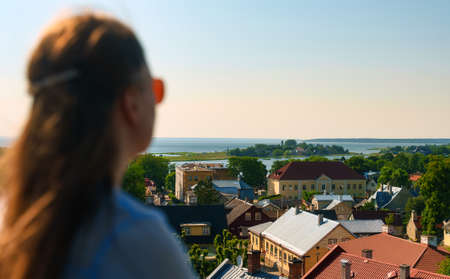 Female tourist looks at the summer Haapsalu.の写真素材