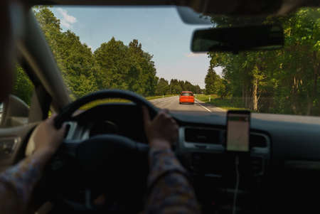 Woman driving a car in summer time.の写真素材
