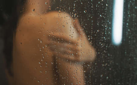 Woman washing herself in the shower.の写真素材