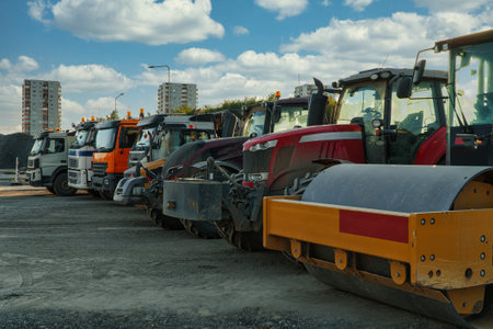 Road construction machinery in the parking lot. Trucks, roller and tractors.