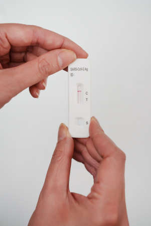 Woman holding NEGATIVE express COVID-19 antigen test.の写真素材