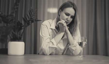 Woman suffering from depression and drinking alcohol.の写真素材