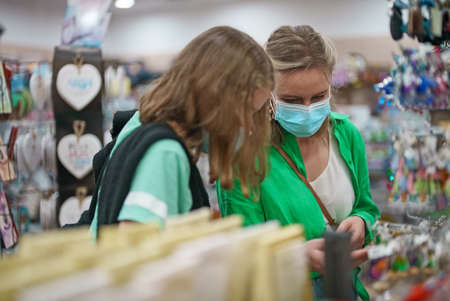 Woman and her daughter in a home decor store.の写真素材