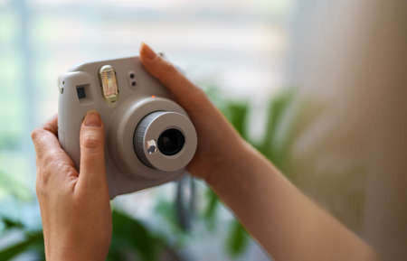 Woman doing selfie photo with instant camera.の写真素材