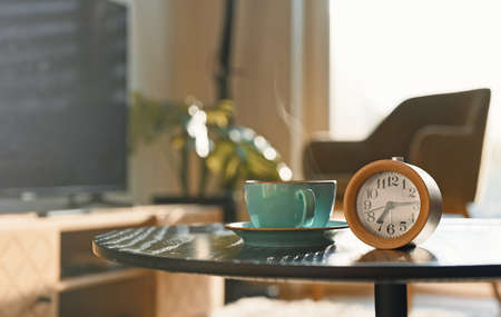 Morning at seven o'clock. Clock and a cup of tea.の写真素材