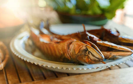 Fresh hot smoked mackerel on the table.の写真素材