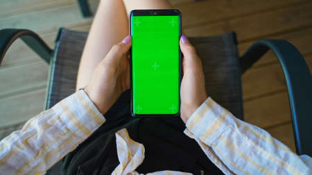 Tween girl with smartphone. Suitable for AD. Green chroma key.の写真素材