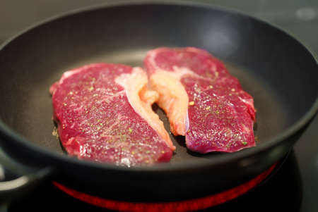 Juicy beef tenderloin is cooked in a skillet.の写真素材