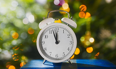 Five minutes before the new year. Clock by the Christmas tree.の写真素材