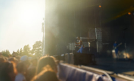 Musical band performing live on the stage. Blurred image.