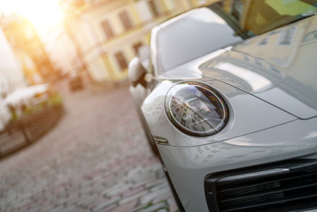 Close-up view of white sports car headlight.